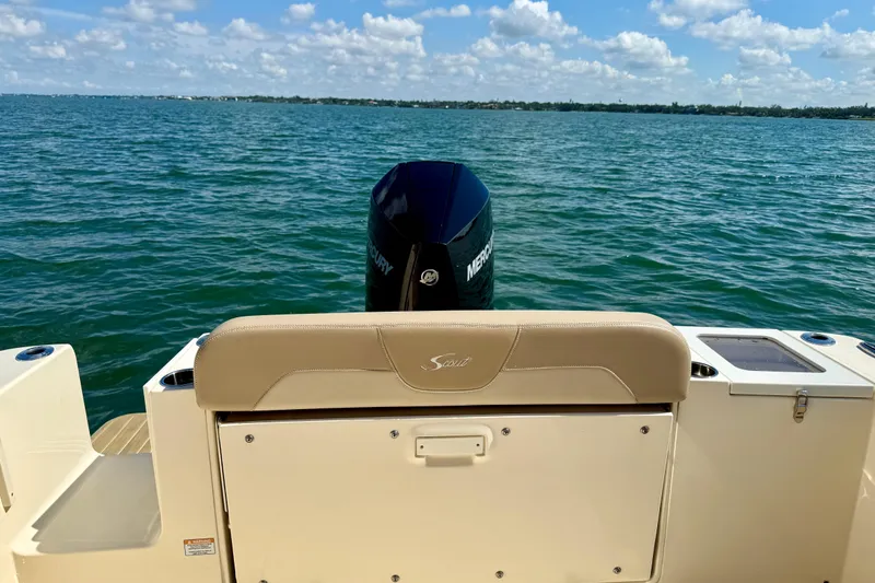 Slide: The Image of 2024 Scout 240 Dorado boat on water, featuring Mercury engine and beige seating. - 9