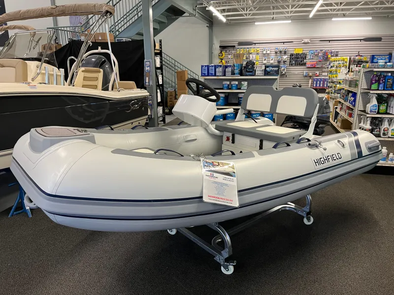 The Image of 2024 Highfield Classic 310 inflatable boat displayed in a showroom. - 1