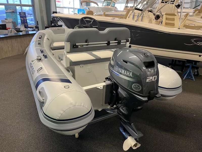 Slide: The Image of 2024 Highfield Classic 310 inflatable boat with Yamaha 20HP outboard motor in showroom. - 2