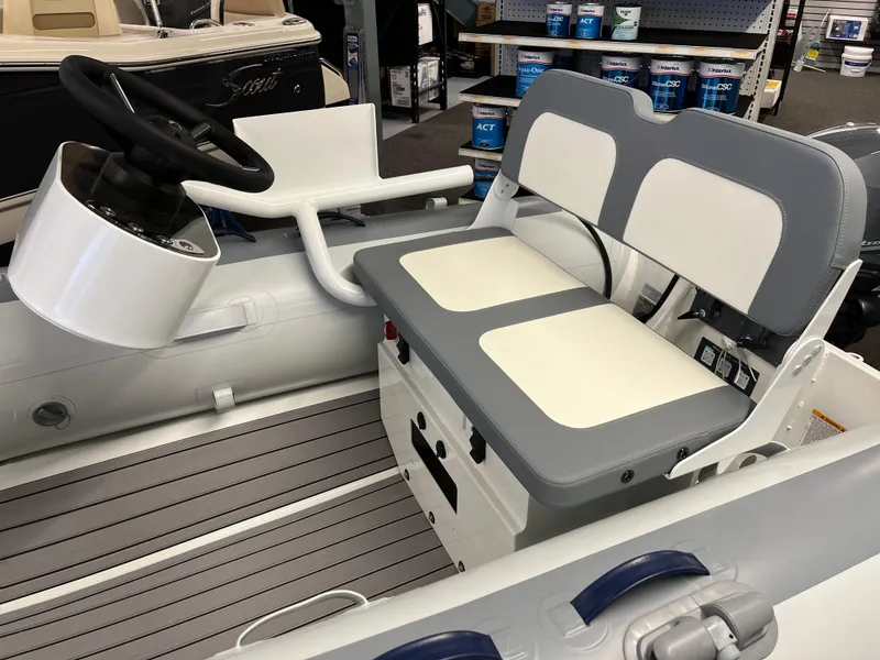 Slide: The Image of 2024 Highfield Classic 310 boat interior with steering wheel and cushioned seating. - 4