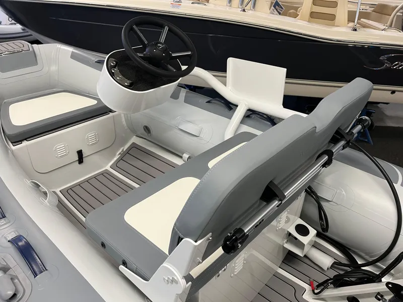 Slide: The Image of 2024 Highfield Classic 310 inflatable boat interior with steering console and seating. - 5