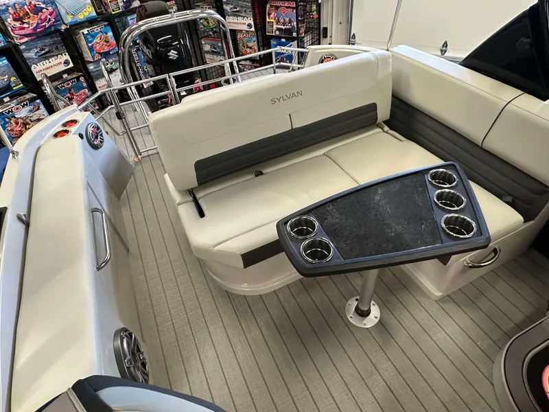 Slide: The Image of 2024 Sylvan G3 CLZ DC boat interior with seating and cupholder table. - 22