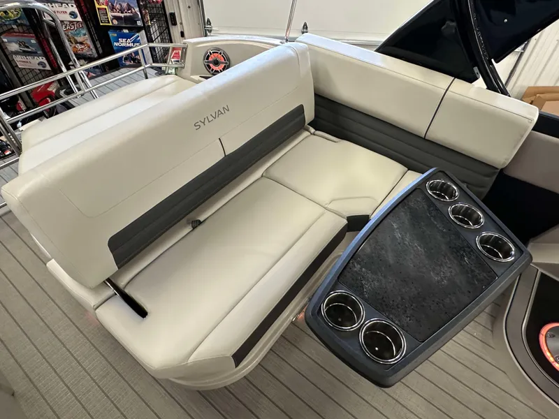 Slide: The Image of 2024 Sylvan G3 CLZ DC boat interior with white seating and cup holders. - 23