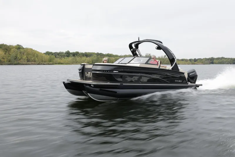 Slide: The Image of 2024 Sylvan G3 CLZ DC pontoon boat cruising on a lake. - 28