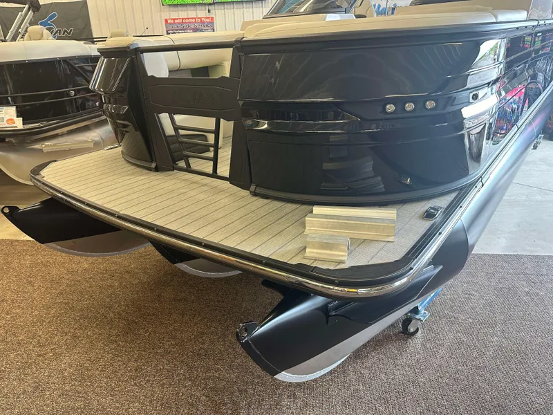 Slide: The Image of 2024 Sylvan G3 CLZ DC pontoon boat, rear view, in showroom setting. - 5