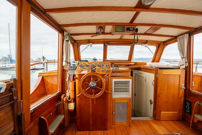 Slide: The Image of 1939 Stephens Brothers Bridgedeck Cruiser interior with wooden helm and classic design. - 10