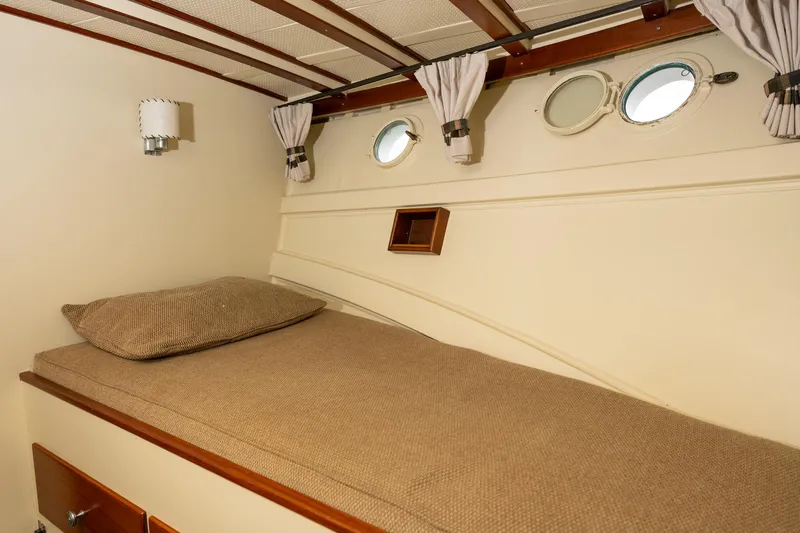 Slide: The Image of 1939 Stephens Brothers Bridgedeck Cruiser cabin interior with bed and portholes. - 12