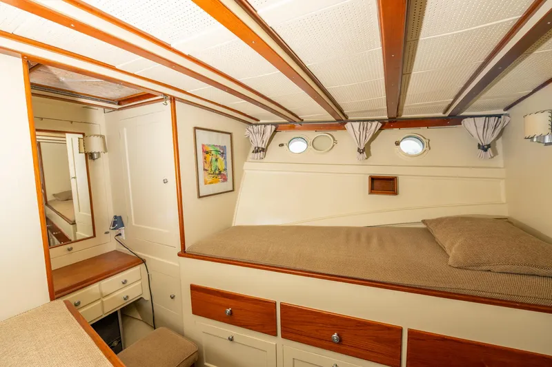 Slide: The Image of 1939 Stephens Brothers Bridgedeck Cruiser cabin interior with bed, portholes, and wooden accents. - 14