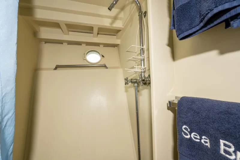 Slide: The Image of Shower area in 1939 Stephens Brothers Bridgedeck Cruiser with porthole and blue towels. - 17