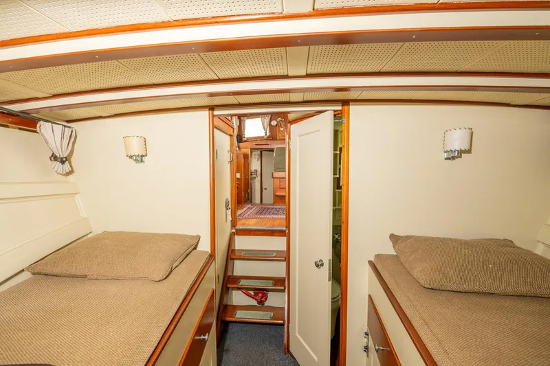 Slide: The Image of Interior of 1939 Stephens Brothers Bridgedeck Cruiser with twin beds and wooden accents. - 18