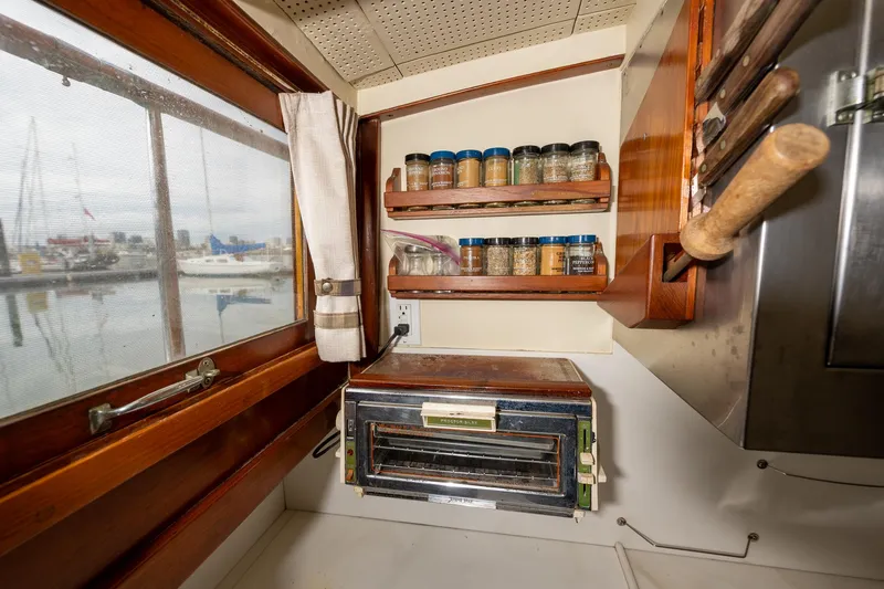 Slide: The Image of 1939 Stephens Brothers Bridgedeck Cruiser kitchen with spices and vintage oven. - 21