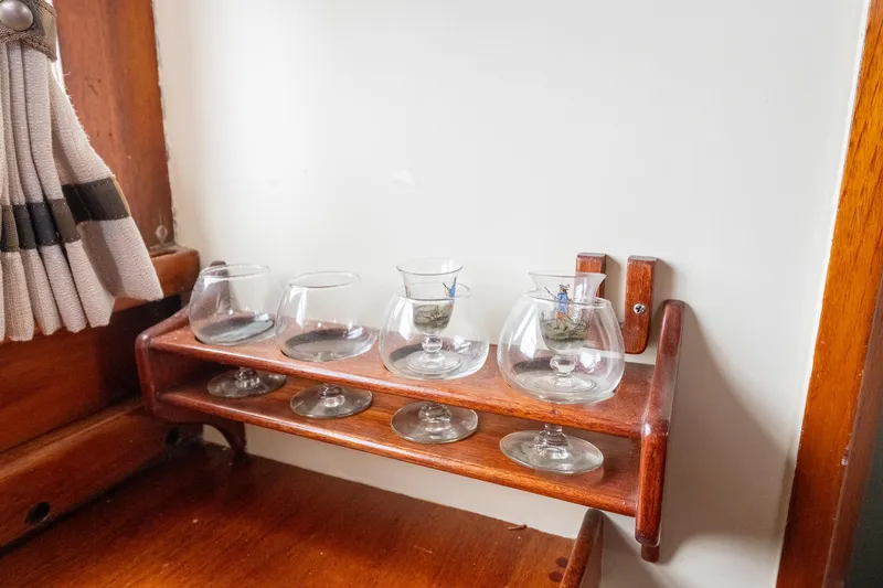 Slide: The Image of Vintage glass holder on 1939 Stephens Brothers Bridgedeck Cruiser, featuring wooden craftsmanship. - 22