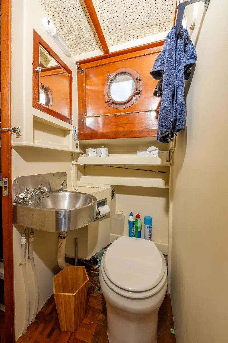 Slide: The Image of 1939 Stephens Brothers Bridgedeck Cruiser bathroom with porthole, sink, and toilet. - 32