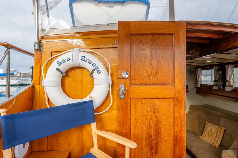 Slide: The Image of 1939 Stephens Brothers Bridgedeck Cruiser with wooden door, life preserver, and blue chair. - 37