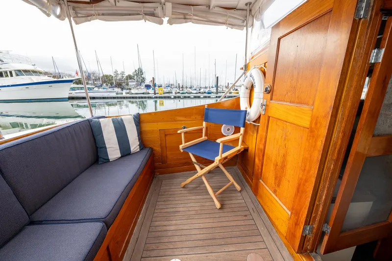 Slide: The Image of 1939 Stephens Brothers Bridgedeck Cruiser interior with wooden paneling and seating at marina. - 40