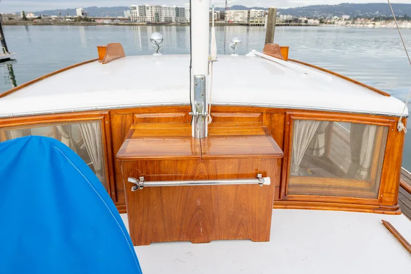 Slide: The Image of 1939 Stephens Brothers Bridgedeck Cruiser with wooden details, docked by the waterfront. - 43