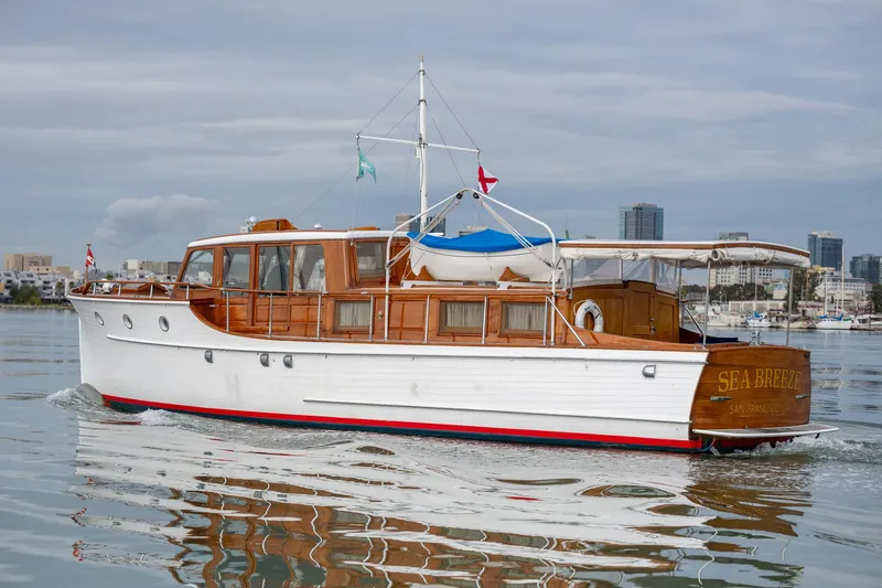 Slide: The Image of 1939 Stephens Brothers Bridgedeck Cruiser on calm water, showcasing classic wooden design and elegant craftsmanship. - 6