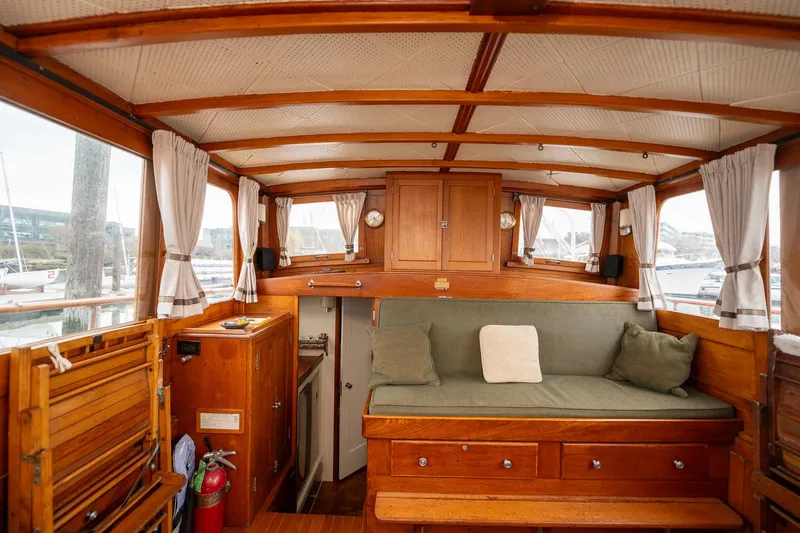 Slide: The Image of Interior of 1939 Stephens Brothers Bridgedeck Cruiser with wooden furnishings and cozy seating. - 9