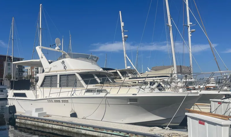 Slide: The Image of 1975 Uniflite Aft Cabin yacht docked at marina, featuring spacious deck and classic design. - 1