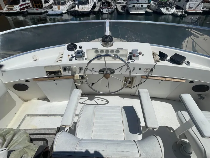 Slide: The Image of 1975 Uniflite Aft Cabin boat deck with turquoise cushions and wooden furniture. - 12