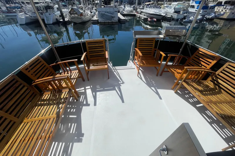 Slide: The Image of 1975 Uniflite Aft Cabin helm with vintage controls and gauges, wooden dashboard, and steering wheel. - 18