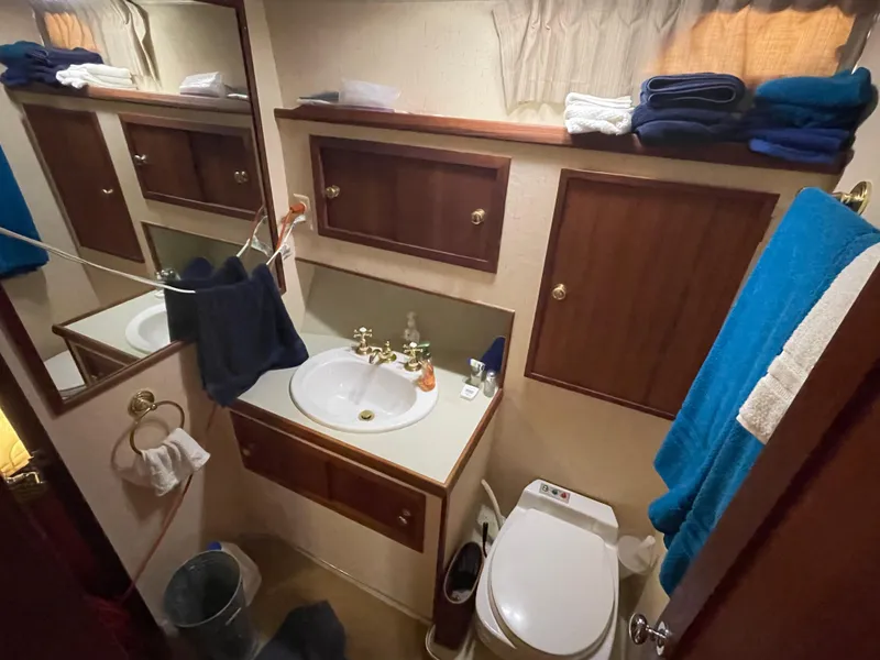 Slide: The Image of Interior of a 1975 Uniflite Aft Cabin with cozy bed and wooden furnishings. - 29