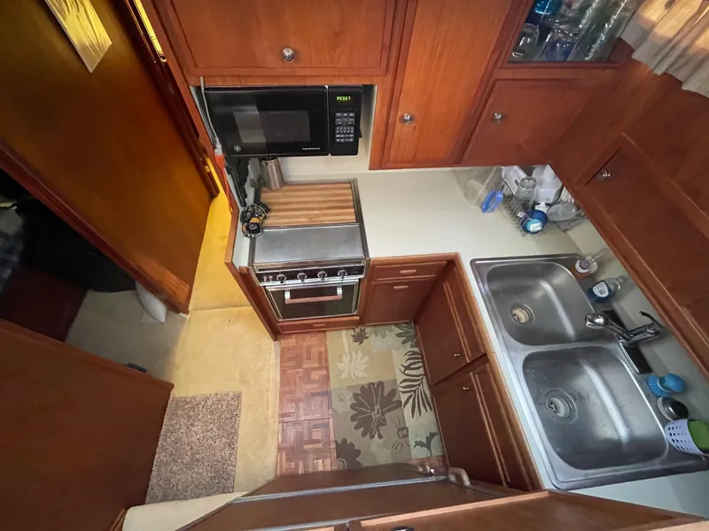 Slide: The Image of Interior of a 1975 Uniflite Aft Cabin with cozy bed and wood paneling. - 30