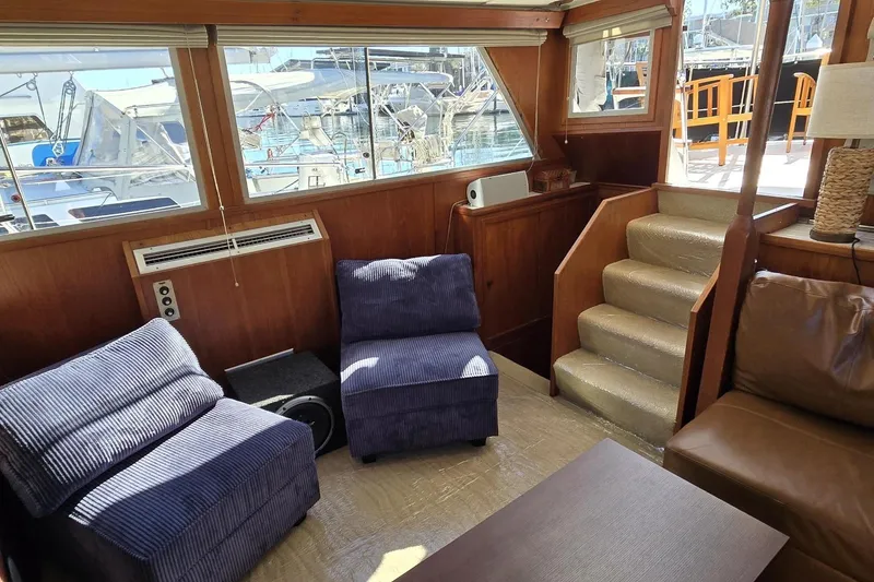 Slide: The Image of 1975 Uniflite Aft Cabin interior with wooden table and leather seating. - 49