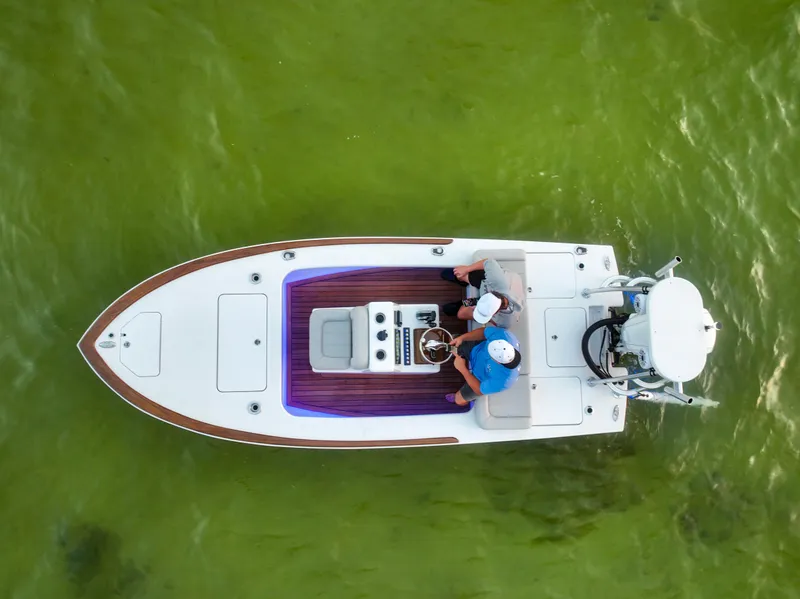 Slide: The Image of 2024 Xcelerator Boatworks 17 Flats on green water, aerial view. - 11
