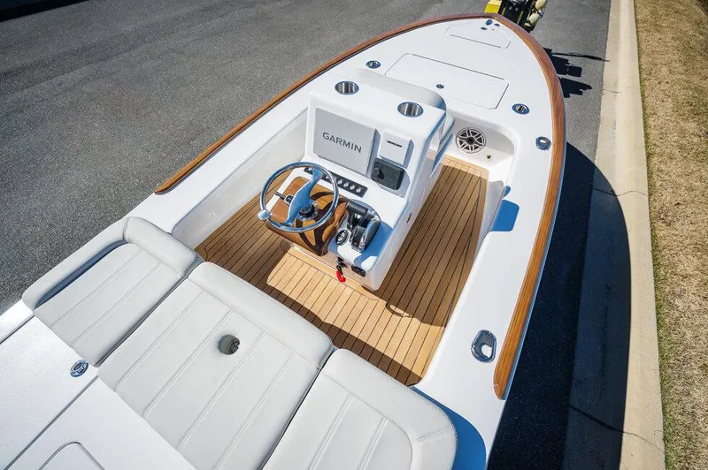 Slide: The Image of 2024 Xcelerator Boatworks 17 Flats with Garmin system, featuring sleek design and wood accents. - 14