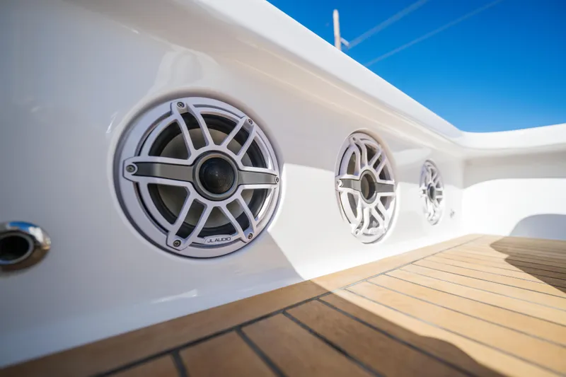 Slide: The Image of 2024 Xcelerator Boatworks 17 Flats with JL Audio speakers on deck. - 16