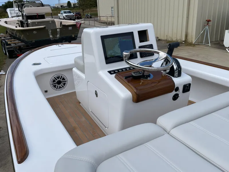 Slide: The Image of 2024 Xcelerator Boatworks 17 Flats boat interior with steering console and seating. - 20