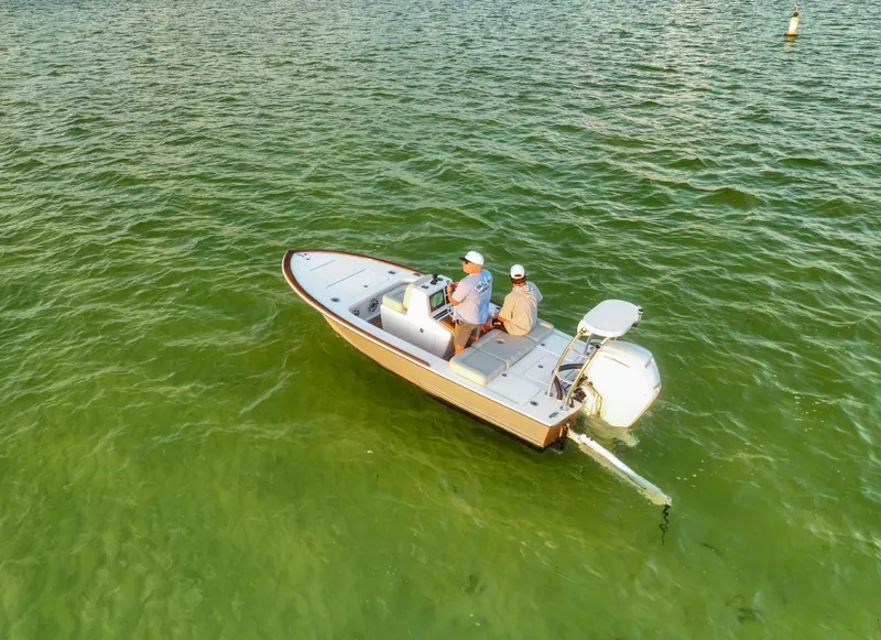 Slide: The Image of 2024 Xcelerator Boatworks 17 Flats on green water, two people aboard. - 3