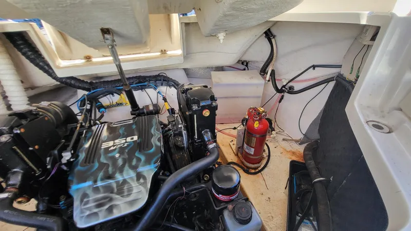Slide: The Image of Engine compartment of a 2007 Chaparral 256 SSi boat with a 350 engine and fire extinguisher. - 13