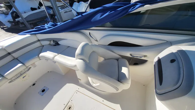 Slide: The Image of 2007 Chaparral 256 SSi boat interior with white seating and blue cover. - 8
