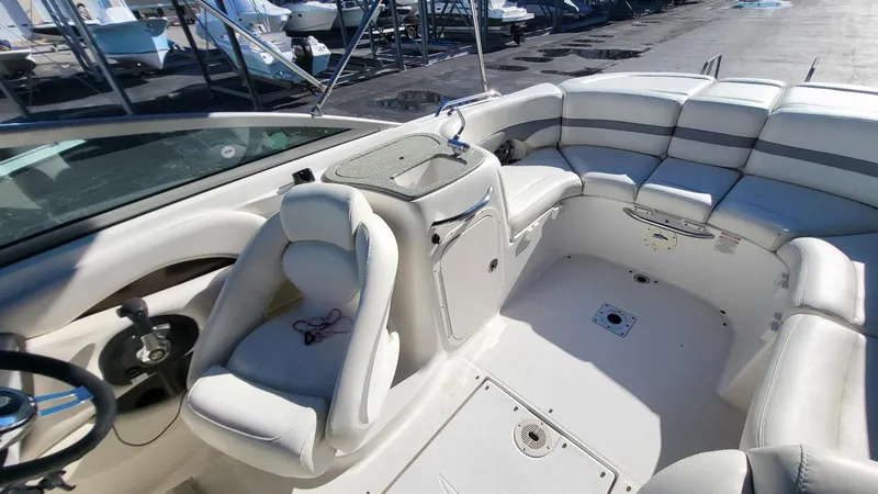 Slide: The Image of 2007 Chaparral 256 SSi boat interior with white seating and steering wheel. - 9