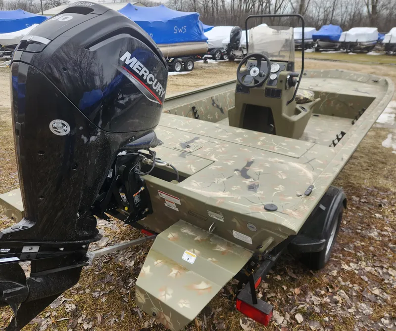 Slide: The Image of 2024 Tracker Grizzly 1860 CC boat with Mercury outboard motor in a storage yard. - 3