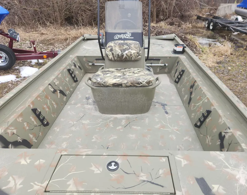 Slide: The Image of 2024 Tracker Grizzly 1860 CC boat with camo interior and center console. - 4