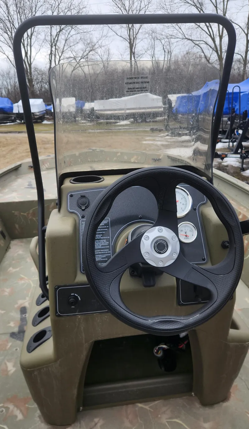 Slide: The Image of 2024 Tracker Grizzly 1860 CC boat console with steering wheel and gauges. - 5
