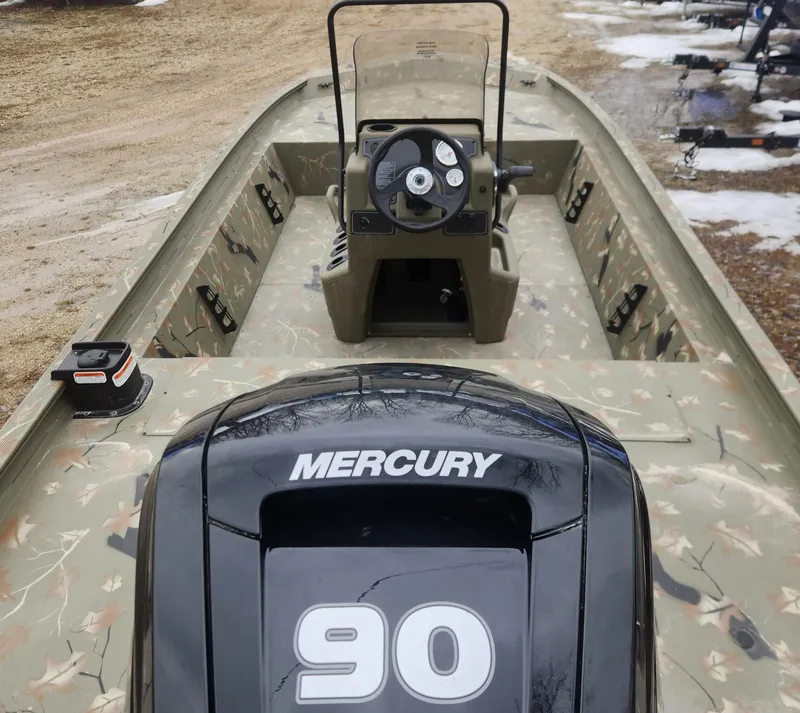 Slide: The Image of 2024 Tracker Grizzly 1860 CC boat with Mercury 90 engine, camo interior, and center console. - 6