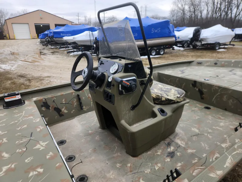 Slide: The Image of 2024 Tracker Grizzly 1860 CC boat with camo interior, center console, and steering wheel. - 7