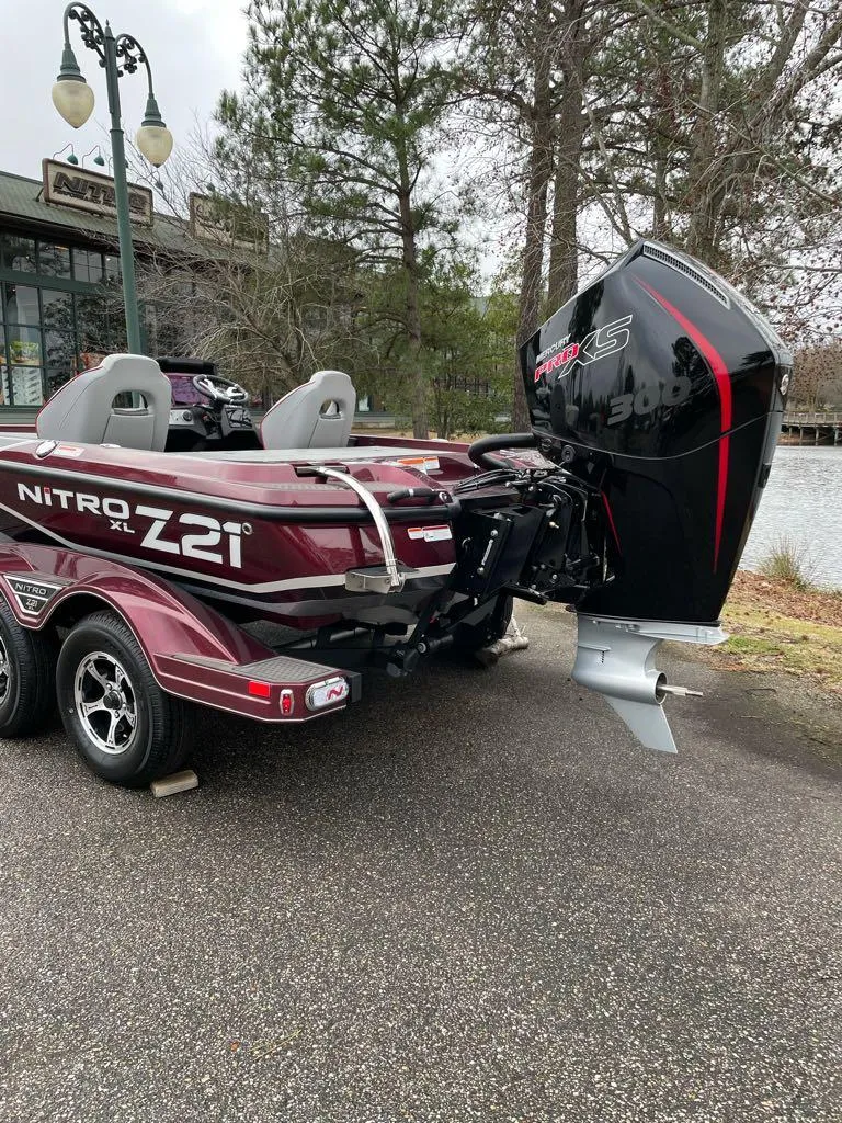 Slide: The Image of 2024 Nitro Z21 XL Pro bass boat with powerful outboard motor. - 5