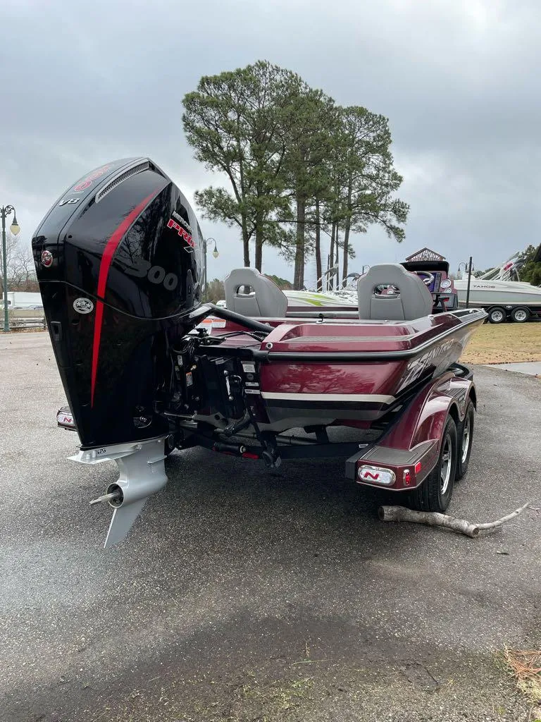 Slide: The Image of 2024 Nitro Z21 XL Pro bass boat with powerful outboard motor. - 6