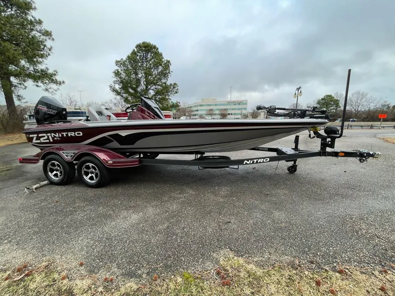 Slide: The Image of 2024 Nitro Z21 XL Pro bass boat on trailer in parking lot. - 7