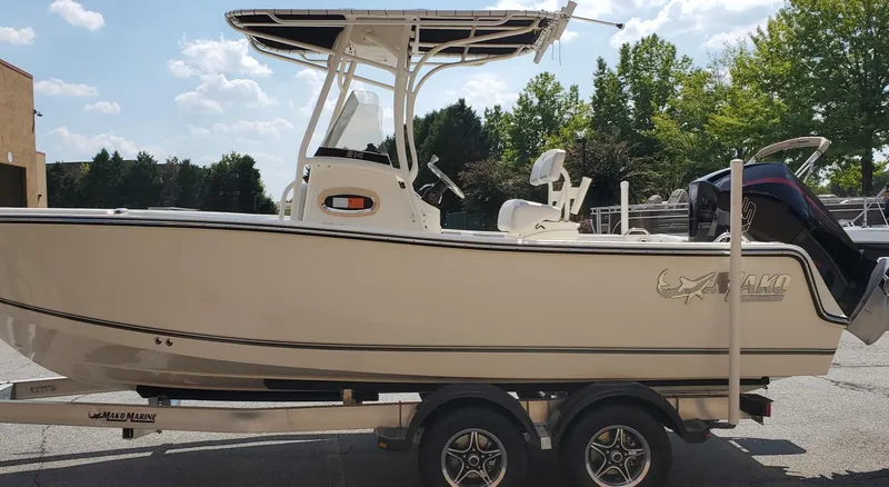 Slide: The Image of 2024 Mako 214 CC boat on trailer, side view, outdoors. - 1