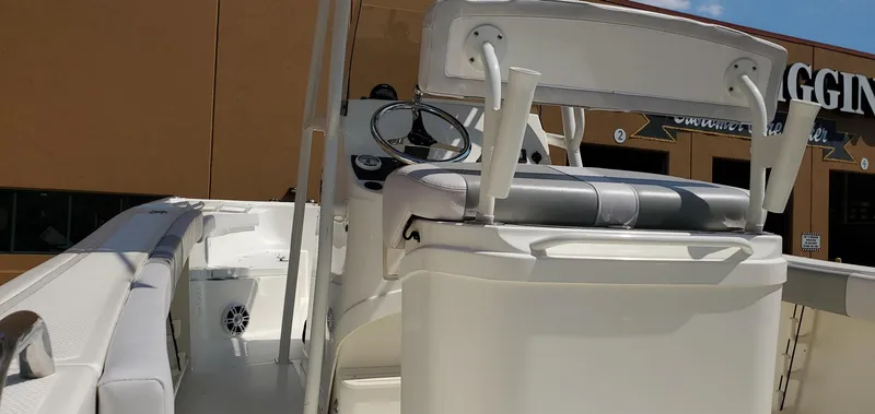 Slide: The Image of 2024 Mako 214 CC boat interior with steering console and seating. - 10