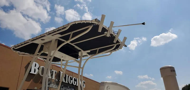 Slide: The Image of 2024 Mako 214 CC boat canopy against a bright blue sky. - 12