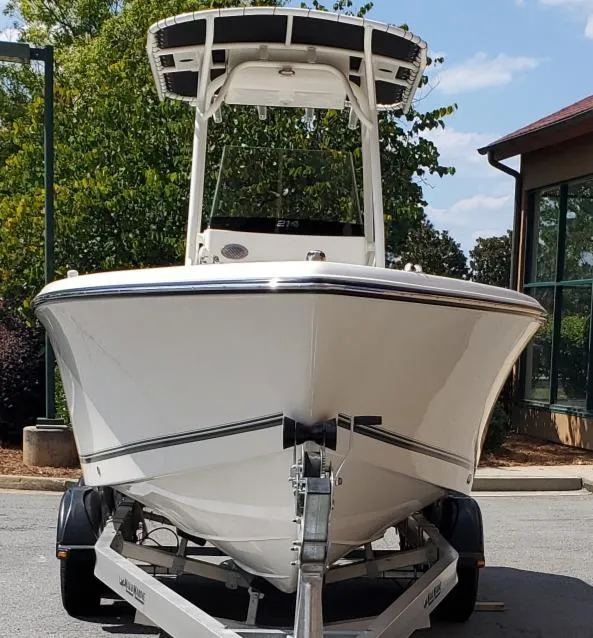 Slide: The Image of 2024 Mako 214 CC boat on trailer, parked outdoors. - 4