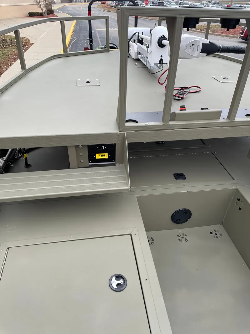 Slide: The Image of 2024 Tracker Grizzly 2072 CC Sportsman boat interior with storage compartments. - 7