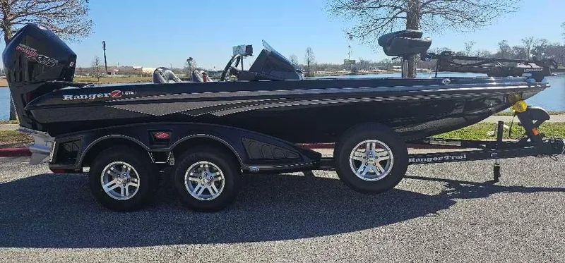 The Image of 2024 Ranger Z518 Ranger Cup Equipped boat on a trailer by a lake. - 0